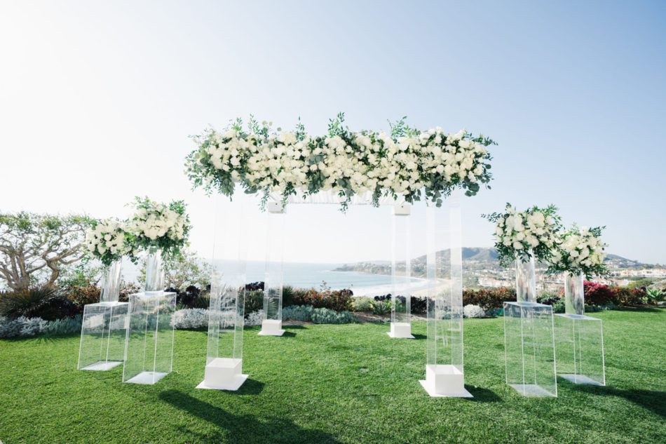 white floral arch, white ceremony blooms, oceanside wedding florals, floral design, florist, wedding florist, wedding flowers, orange county weddings, orange county wedding florist, orange county florist, orange county floral design, flowers by cina