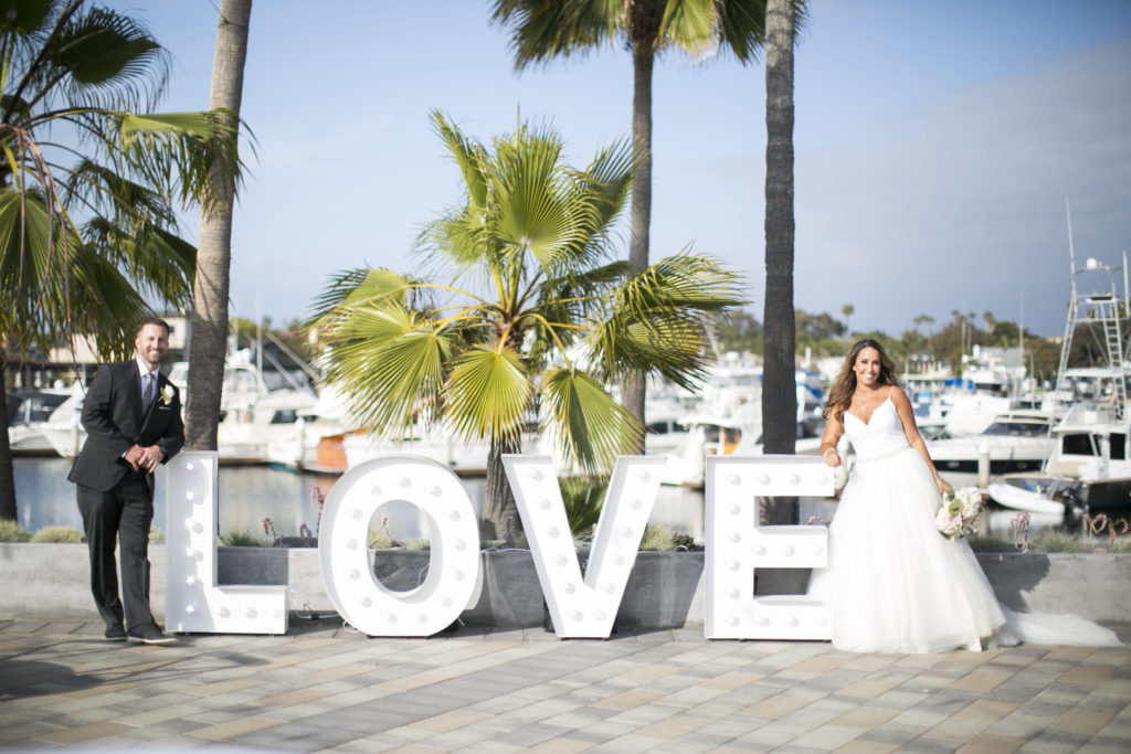 bride and groom, harbor wedding, love sign, floral design, florist, wedding florist, wedding flowers, orange county weddings, orange county wedding florist, orange county florist, orange county floral design, flowers by cina