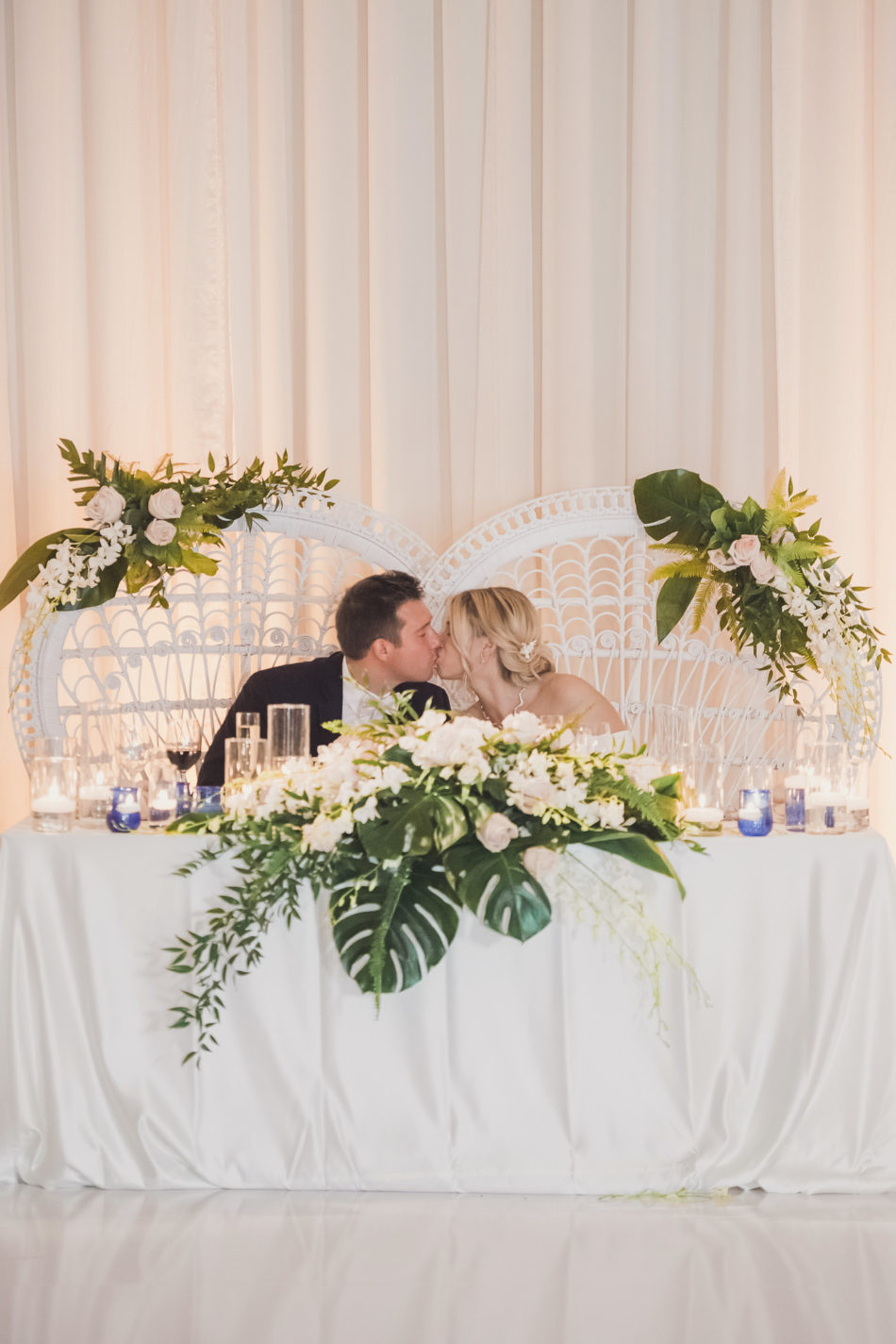 sweetheart table, newlywed kiss, romantic pastel-hued wedding, floral design, florist, wedding florist, wedding flowers, orange county weddings, orange county wedding florist, orange county florist, orange county floral design, flowers by cina