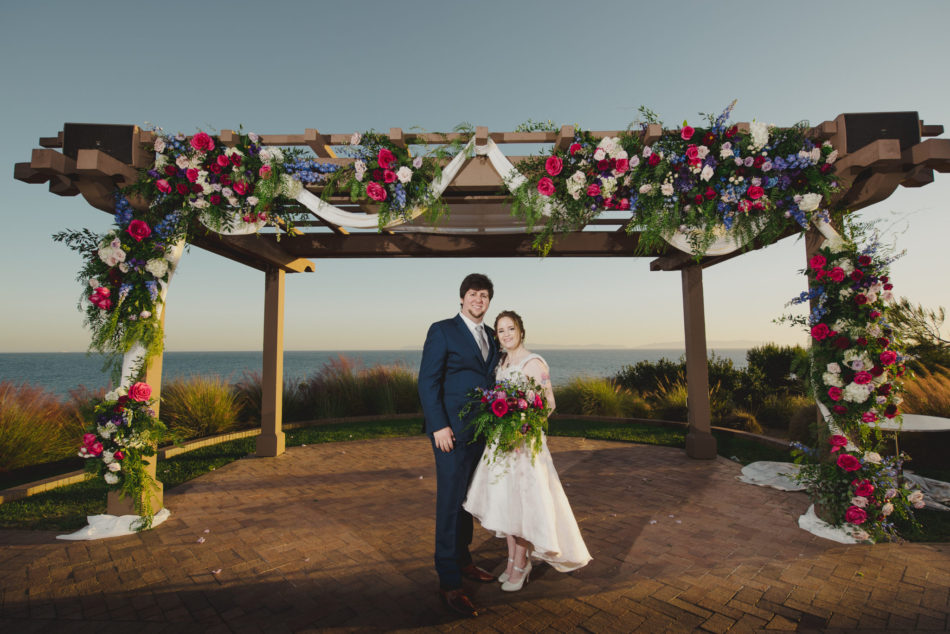 bride and groom, ceremony arch, vibrant oceanfront wedding, floral design, florist, wedding florist, wedding flowers, orange county weddings, orange county wedding florist, orange county florist, orange county floral design, flowers by cina