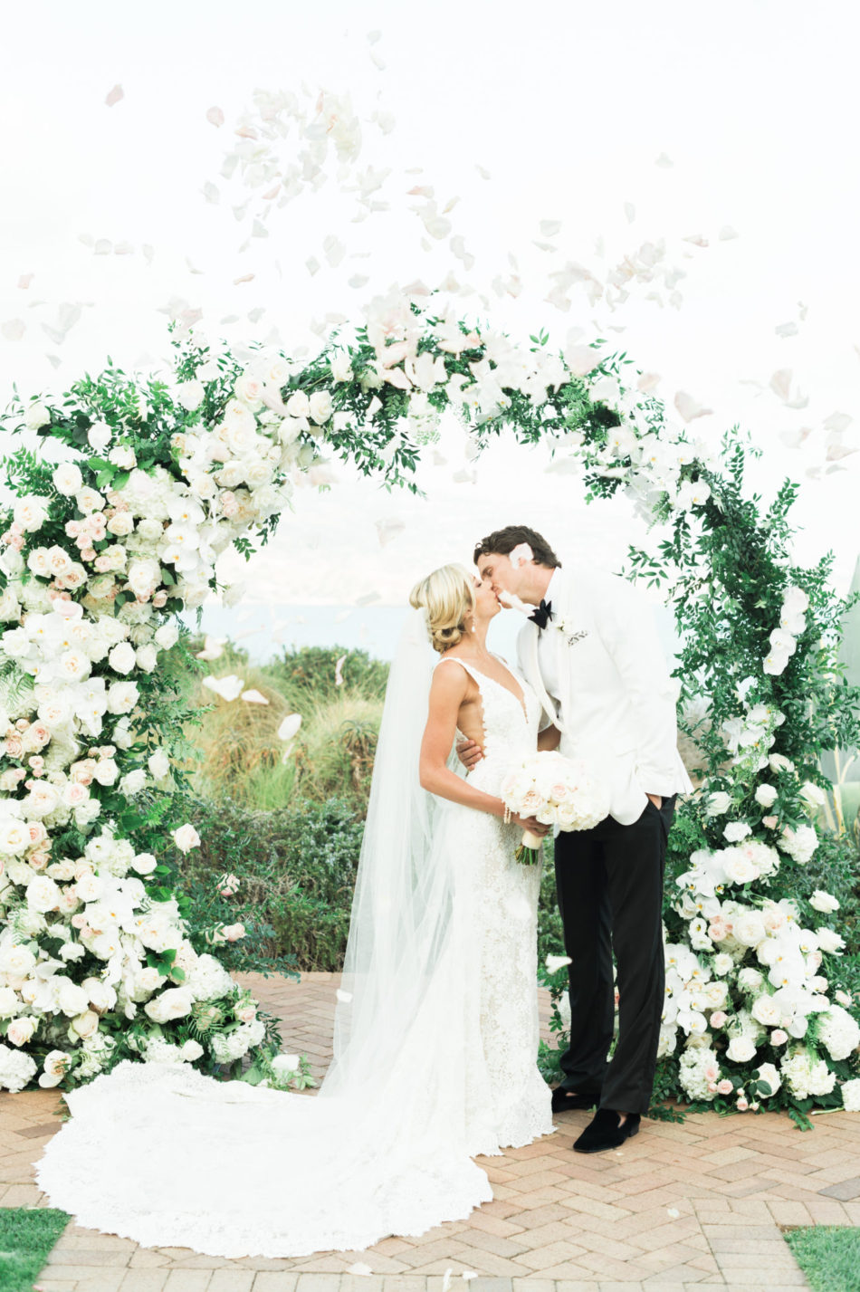 first kiss, bride and groom, romantic all-white wedding, floral design, florist, wedding florist, wedding flowers, orange county weddings, orange county wedding florist, orange county florist, orange county floral design, flowers by cina