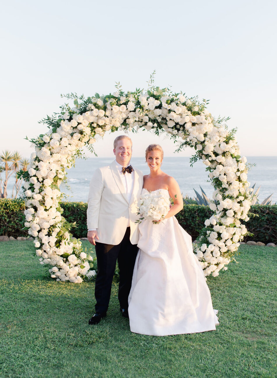 newlyweds, floral arch, ceremony arch, gorgeous oceanfront wedding, floral design, florist, wedding florist, wedding flowers, orange county weddings, orange county wedding florist, orange county florist, orange county floral design, flowers by cina