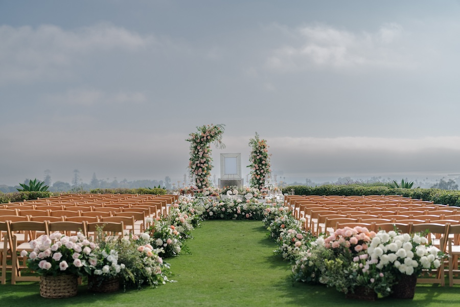 Wedding ceremony aisle and Sofreh lined in flowers. 