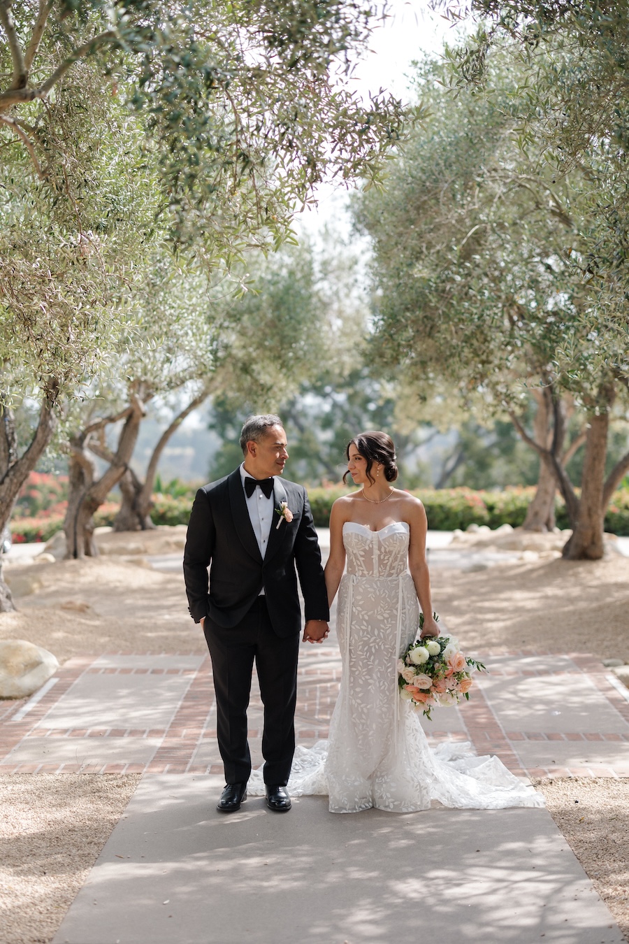 Bride and groom posed together outdoors.